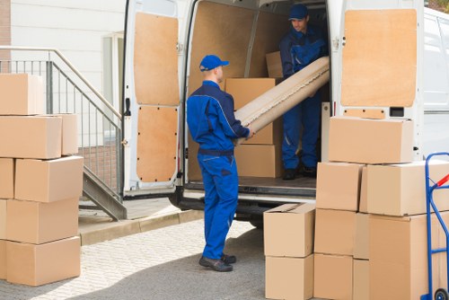 Moving van and packed boxes outside a Barnes home