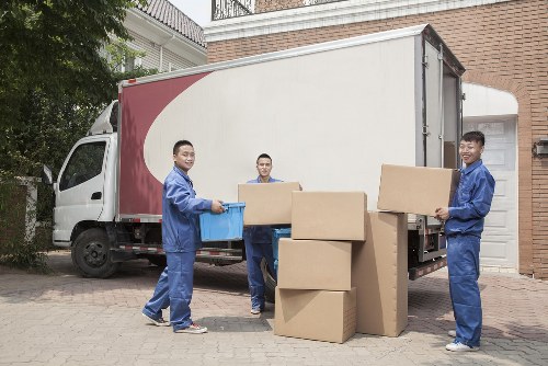 Professional flat removals in Barnes with a moving team handling boxes and furniture
