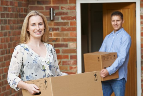 Removal team carrying boxes and furniture during a same-day move