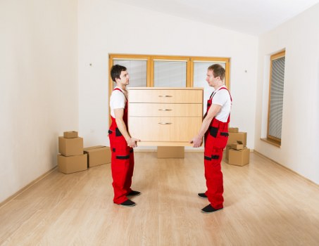 Packed moving boxes and furniture prepared for a home removal in Barnes
